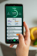 © JULIA - A person holds a smartphone displaying a calorie tracking application with nutritional data. The image represents healthy lifestyle management, digital wellness, and conscious eating habits.