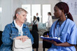 © DC Studio - Documentation, nurse and senior patient during hospital consultation as healthcare worker writes notes on clipboard for symptom review, medical assessment, communication and ongoing care.
