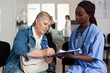 © DC Studio - Paperwork, nurse and patient as senior woman signs medical form on clipboard during hospital consultation, with documentation support, appointment administration and healthcare service.