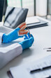 © Charlie's - Dentist Holding Dental Model While Explaining Oral Health and Treatment Information During Consultation in Modern Clinic
