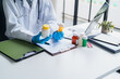 © Charlie's - Doctor Holding Medicine Bottle While Providing Professional Healthcare and Medication Information in Modern Clinic.