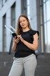 © wolfhound911 - Medium portrait of business woman using smartphone outdoors
