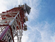 © David-CASSESE - Low angle view of telecommunication tower with antennas against blue sky