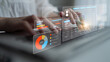 © InfiniteFlow - Modern Business Professional Analyzing Data Through Innovative Technology Interface with Graphs and Charts on Keyboard While Working in Office Environment. Glyphic.