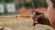 © Anna - Kid aiming with bow and arrow at target during archery practice
