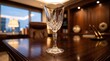 © Yuliyanti - Elegant crystal wine glass on a polished wooden desk in a luxury executive office