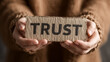 © Gulam - Hands holding rustic cardboard sign with trust message for business