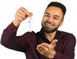 © fotofabrika - Man holding keys and smiling while looking at them in a well-lit indoor space