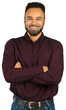 © fotofabrika - Young man smiles while standing with arms crossed and wearing a maroon shirt in a neutral background