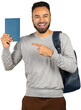 © fotofabrika - Young man smiles and shows notebook while standing indoors with backpack