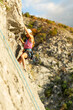 © prelevicm - Girls climbing a rock face with ropes and harnesses during an outdoor climbing session