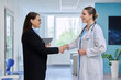 © Valerii Honcharuk - Pharma representative shaking hands with doctor in hospital corridor shot