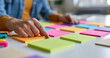 © Anastasiya Marchenko - Person organizing colorful sticky notes