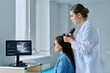 © Valerii Honcharuk - Trichologist examining patient hair and scalp using trichoscope in medical clinic