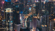 © Amazing Aerial - Aerial view of the illuminated Jakarta skyline at night with dense skyscrapers, glowing office buildings, and busy traffic trails on the roads below in Jakarta, Indonesia.