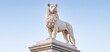 © ckybe - A stone guardian statue with detailed texture stands at a historic Oslo government building in gentle morning light.