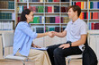 © Valerii Honcharuk - Psychologist woman and male student shaking hands during consultation