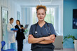 © Valerii Honcharuk - Confident female doctor in medical scrubs with stethoscope in hospital corridor
