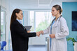 © Valerii Honcharuk - Pharmaceutical sales representative and doctor shaking hands in a hospital