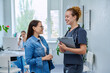 © Valerii Honcharuk - Smiling young female nurse talking to mature patient in hospital office
