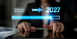 © InfiniteFlow - Digital Transition Between Years 2026 and 2027 with Progress Indicator on a Tablet Device in a Professional Business Environment. Liminal.
