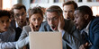 © S-DESIGN - A group of diverse business people looking at a laptop screen with shock and disbelief. Their mouths are agape and eyes wide as they react to something on the screen