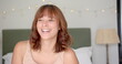 © WavebreakMediaMicro - Young woman with a joyful expression, indoors, in a bedroom