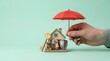 © Fahmi87 - A conceptual representation of home insurance featuring a protective umbrella held over a miniature family home to symbolize safety and financial security