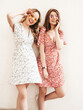 © halayalex - Two young beautiful smiling hipster in trendy summer sundress.Sexy carefree women posing in the street near wall in sunglasses. Positive models having fun and going crazy