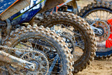 Motocross dirt bikes with muddy knobby tires after racing