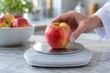 © Thi - older adult weighing an apple for healthy living