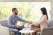 © Pixel-Shot - Business partnership and professional agreement, man and woman shaking hands during a job interview or corporate meeting in a bright modern office