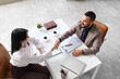 © Pixel-Shot - Job interview success and professional hiring, recruiter and candidate shaking hands after successful meeting in modern office with resume on desk