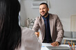 © Pixel-Shot - Business partnership and professional agreement, smiling man shaking hands with a colleague during a corporate meeting in a modern office environment