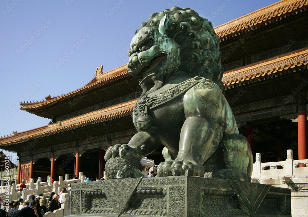 Fototapeta premium lion playing a ball - a sculpture of palace gugun