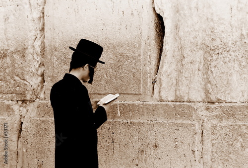 jew is praying by the western wall, jerusalem