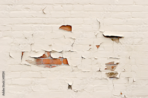 peeling paint over brick wall