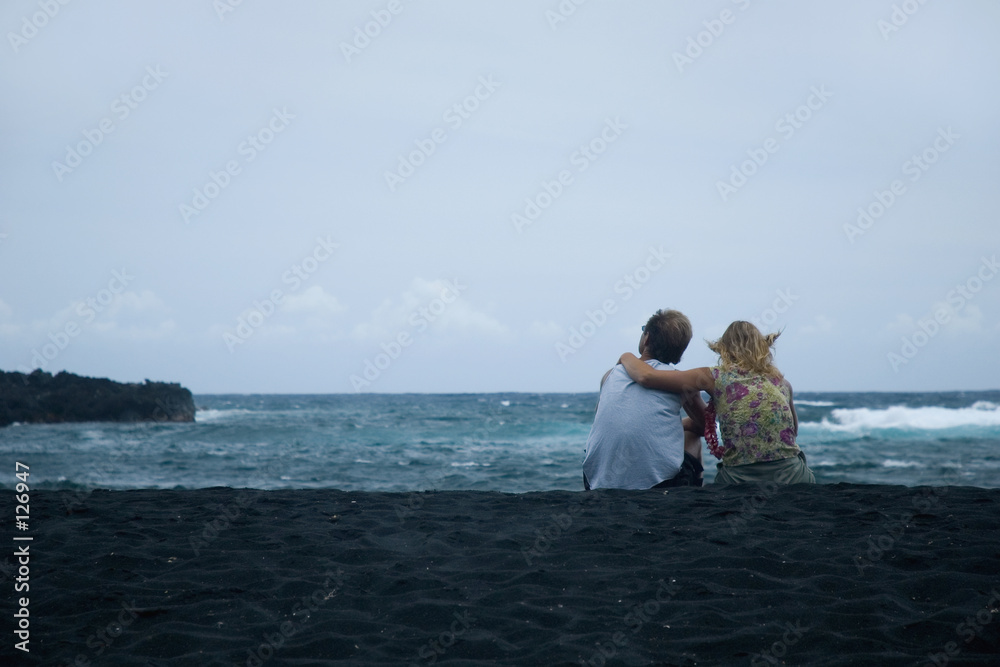 couple sitting on the sand