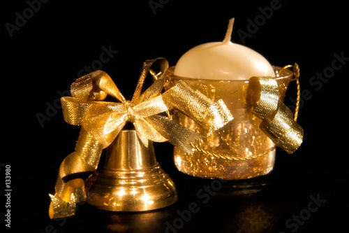 gold christmas handbell and candle