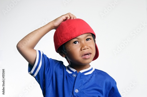 confused kid in red baseball cap