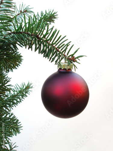 red christmas ball hanging on a christmas tree