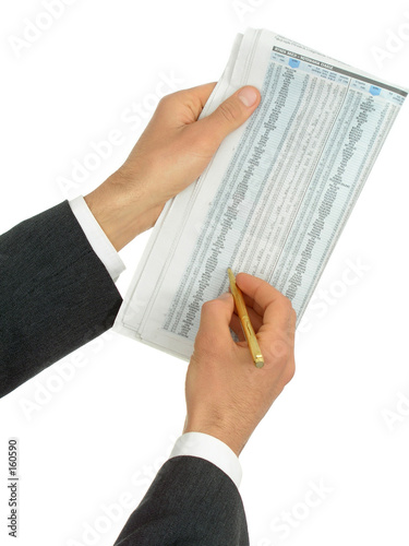 hands holding newspaper with stock reports photo