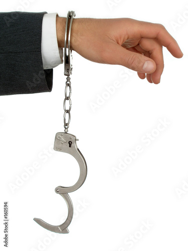 businessman's hand in handcuffs