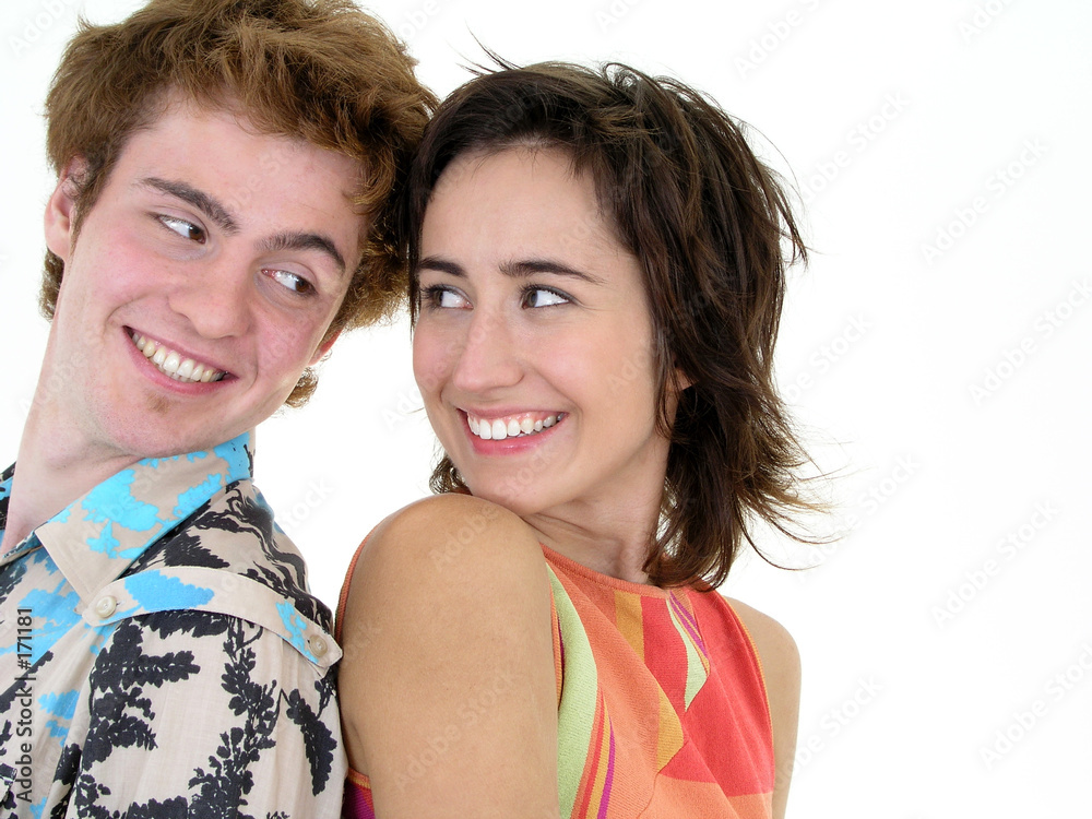 happy couple standing back to back happy couple standing back to back