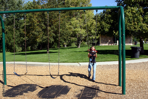Vászonkép little boy swinging