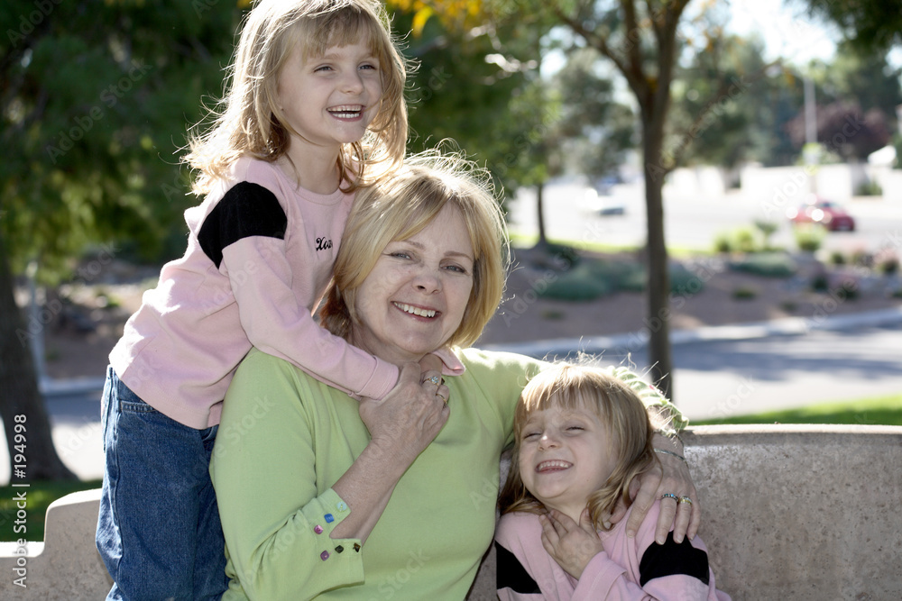 Fototapeta premium twins hugging grandma