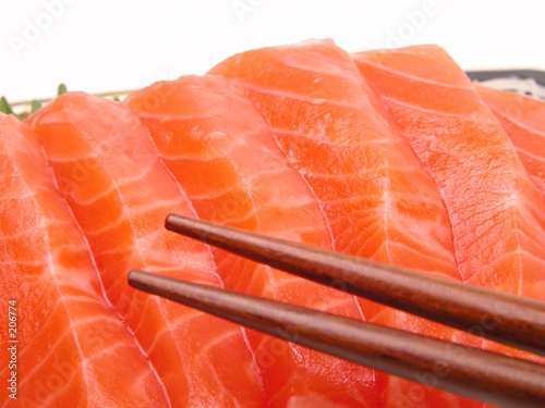 chopsticks and salmon meat photo