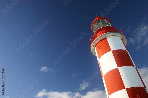lighthouse under a deep blue sky