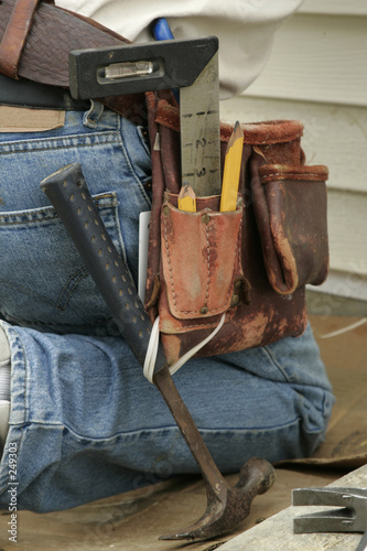 kneeling worker and tool belt