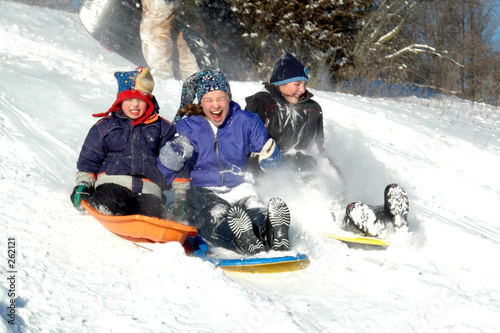 three kids sledding